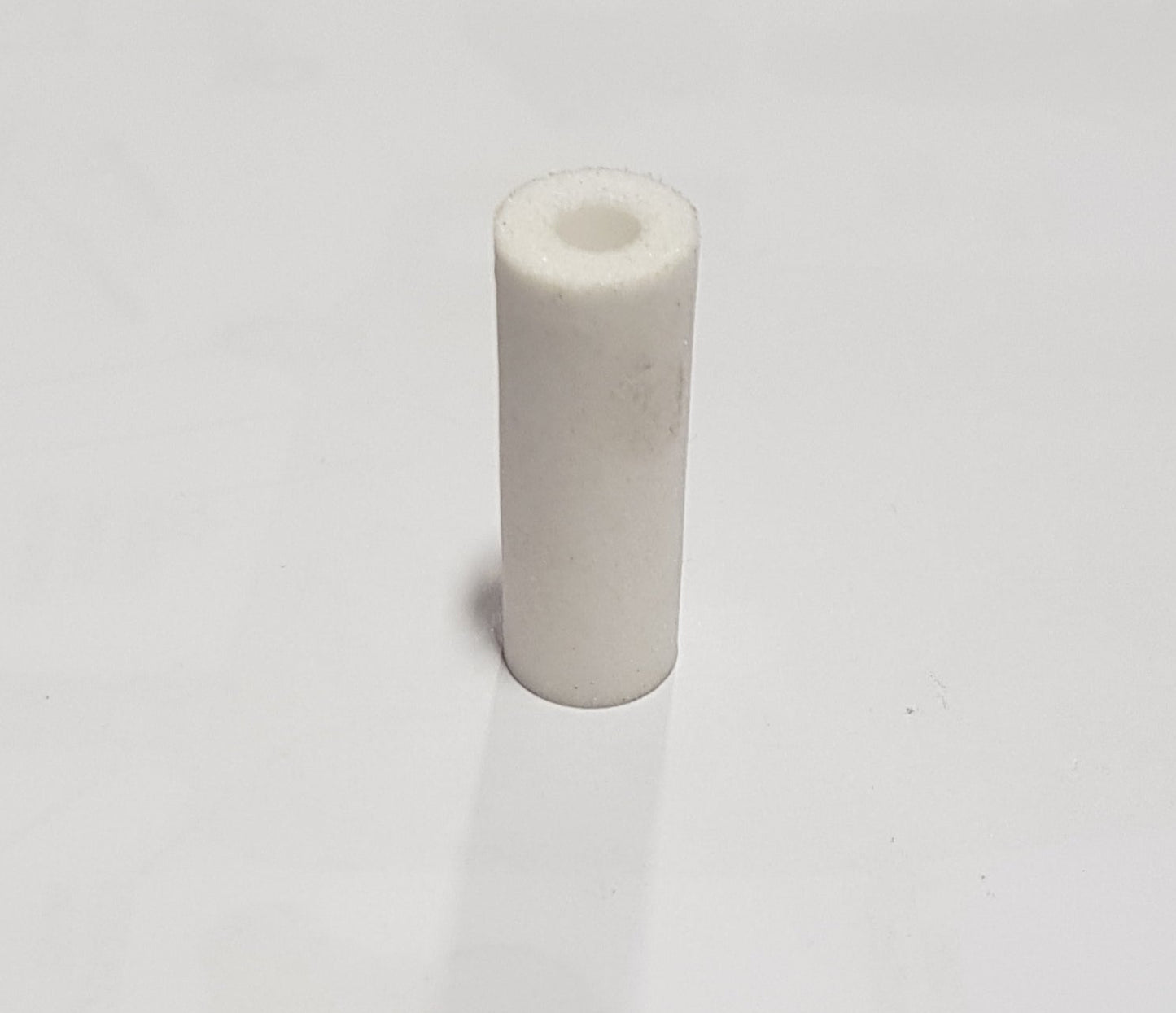 Injector sintered filter for a V2 type powder feed pump, predominantly white in color, with product number C07 540009 displayed.